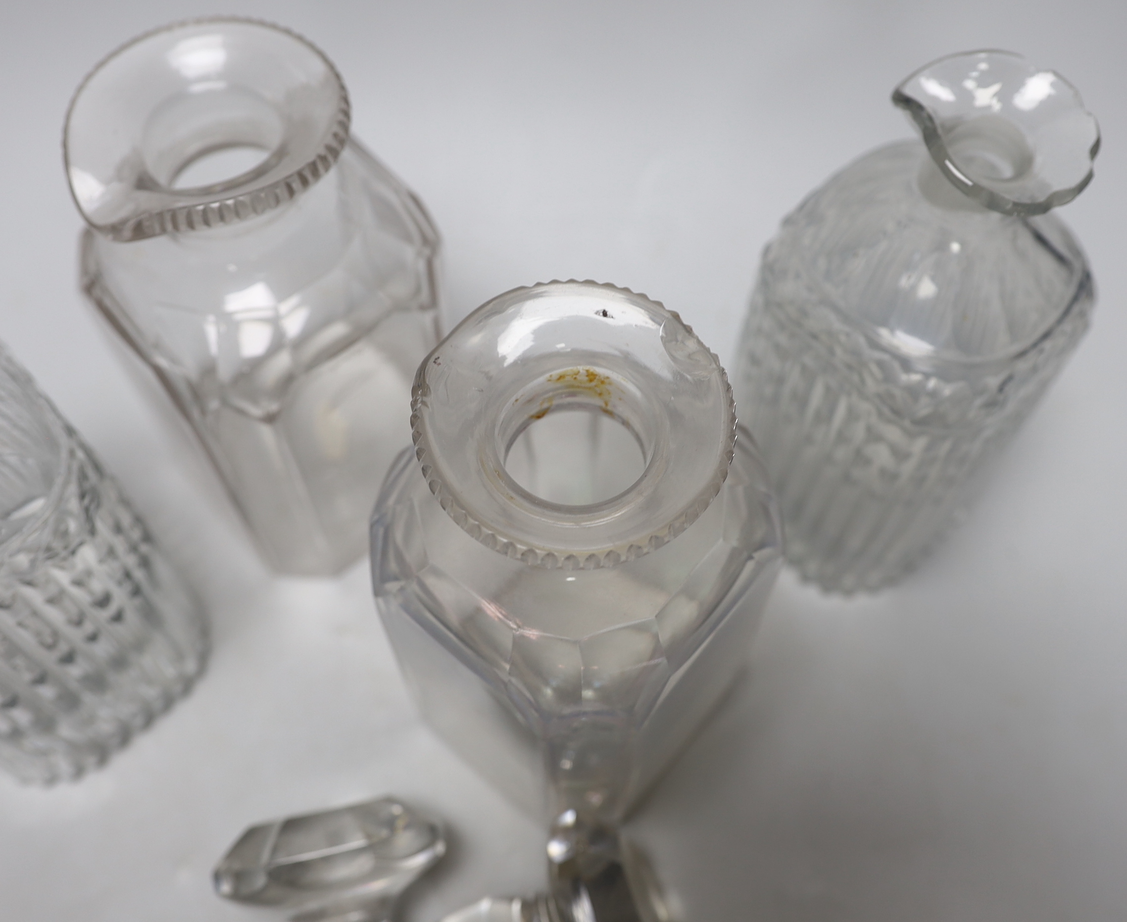 Two pairs of Georgian moulded and cut glass square decanters, all with lips, stoppers and ground pontils, highest 20cm (4)